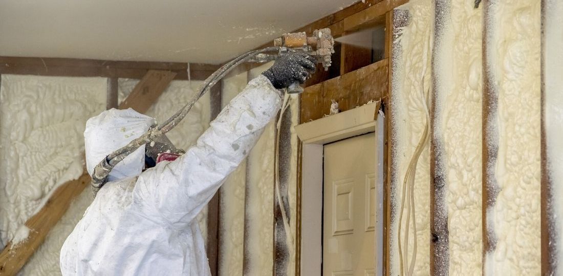 man using spray foam insulation